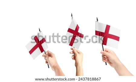 A group of people are holding small flags of England in their hands.