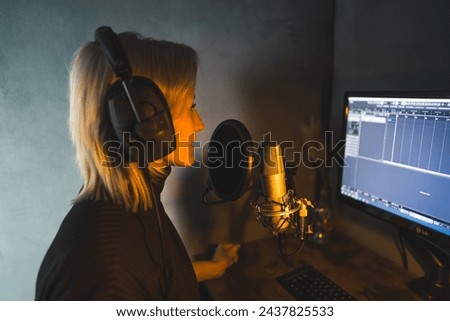 Young woman working as a presenter at a radio station, medium side view shot, podcasting studio. High quality photo