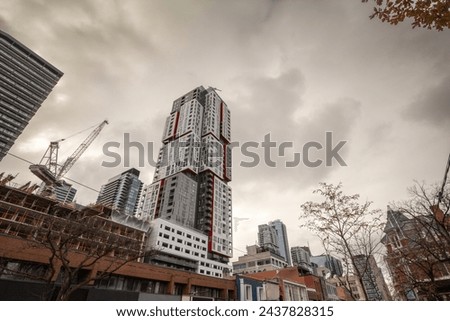 Construction sites of rise condo apartment building towers on Queen Street, in an area of downtown Toronto being redeveloped, in the economic center of Canada, Toronto. Royalty-Free Stock Photo #2437828315