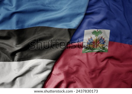 big waving national colorful flag of haiti and national flag of estonia. macro