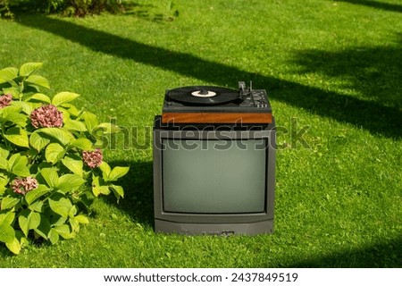 old TV and record player in the garden