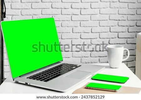 laptop with green screen on various tables with interesting view