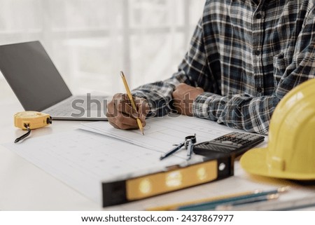 Architect drafts blueprints, house building plans, architectural engineers, drafts designs. Infrastructure, paper table and laptop with vision in construction, work at home concept, close-up image