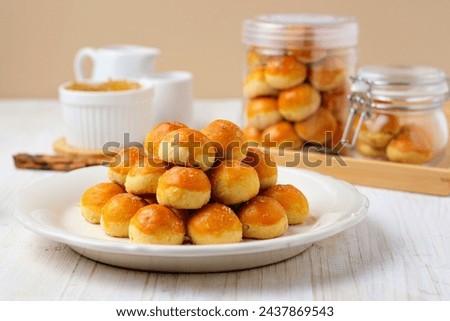 Kue nastar or pineapple tart. indonesian eid snack (kue lebaran). on a white plate. bright mood style. perfect for recipe, article, catalogue, or any commercial purposes. Royalty-Free Stock Photo #2437869543
