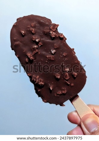 Chocolate Crisp Ice Cream Bar on a blue background
