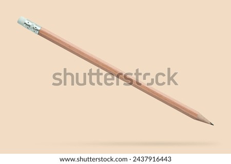 Brown pencil floated on brown background close up