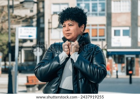 portrait of african american woman with leather jacket in the city