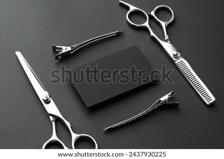 Hairdressing scissors and businesscard mock up on black background