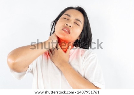Unhealthy dark haired woman touching neck feeling pain and numbness, worried about muscle tension, osteochondrosis, wearing casual style jacket. Indoor studio shoot isolated on gray background.