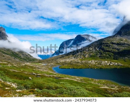 Mountains, lakes and blue sky over trollveggen Norway on a beautiful summer day. High quality photo Royalty-Free Stock Photo #2437934073