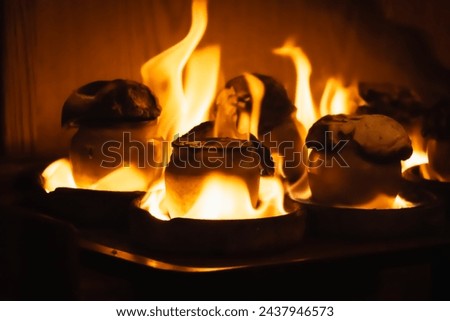 Close-up of Testi Kebab in clay jug on fire Royalty-Free Stock Photo #2437946573