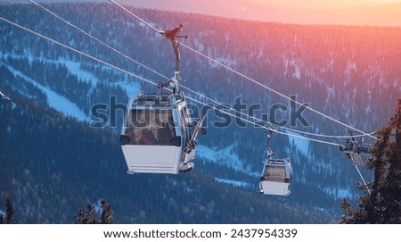 Banner ski lift resort in winter, Aerial top view Sheregesh, forest landscape on mountain with sunset light, Kemerovo region Russia.