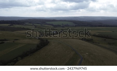 Country Road Winding through Early Springtime Rural Landscape
