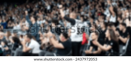 blurred crowd of people at a sports event in arena