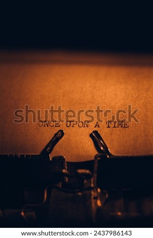 ONCE UPON A TIME typed words on a vintage typewriter. Close up. Antique Typewriter. Royalty-Free Stock Photo #2437986143