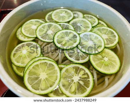 Cold sudachi soba noodles topped with slices of sudachi(species of Japanese citrus, Citrus sudachi), a specialty of Tokushima  Royalty-Free Stock Photo #2437988249