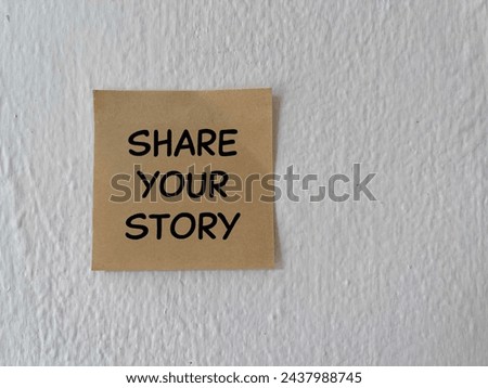 Motivational and inspirational wording. SHARE YOUR STORY written on a paper. On white background. Royalty-Free Stock Photo #2437988745
