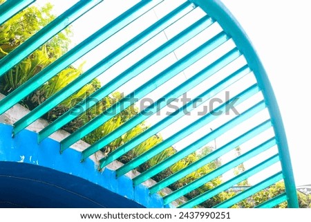 view of the iconic tunnel at the wisdom park of Gadjah Mada University, Yogyakarta. Blue paint tunnel design with aesthetic vines Royalty-Free Stock Photo #2437990251