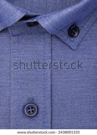 Close-up of a button placket on a blue violet shirt