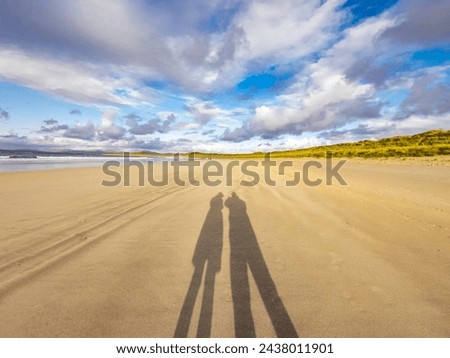 Shadow of couple enjoying the beach