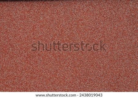 red wall covering with small stones on the wall