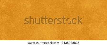 Dark orange matte background of suede fabric, closeup. Velvet texture of seamless golden textile, macro. Structure of ocher felt canvas backdrop.