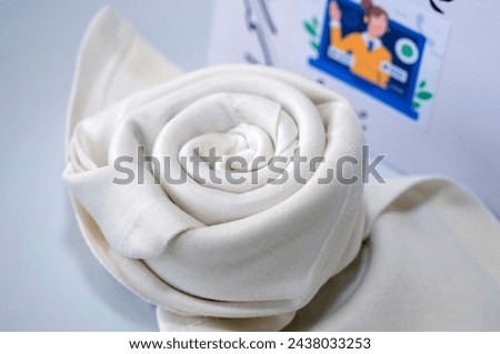 white napkin with rose shape