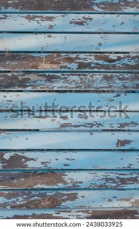 Aged Patina on Weathered Blue Wooden Boards. The Rustic Charm of Faded Paint and Time-Worn Wood. Outdoor Royalty-Free Stock Photo #2438033925