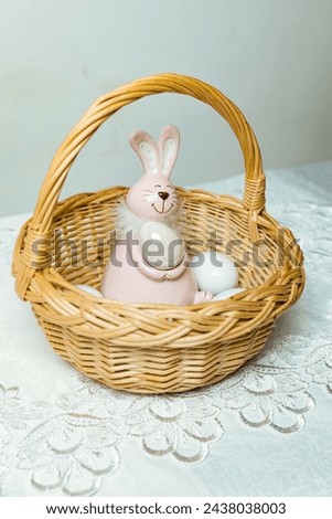 Easter bunny with eggs in a basket with willow