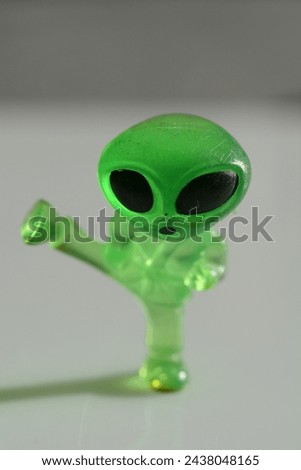 little green alien throwing a side-kick