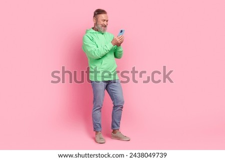 Full body photo of nice retired male hold telephone ecommerce wear trendy green outfit isolated on pink color background