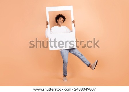 Full length photo of positive optimistic guy wear trendy clothes dance hold photography isolated on beige color background