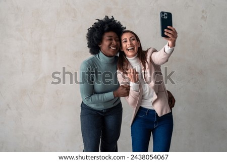 Happy smiling young woman taking selfies with her best friend.