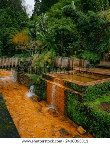 A panorama picture of the Poça da Dona Beija thermal waters complex. Natural hot spring at Pocas da Dona Beija where people swim in warm water in Sao Miguel island, Azores, Portugal