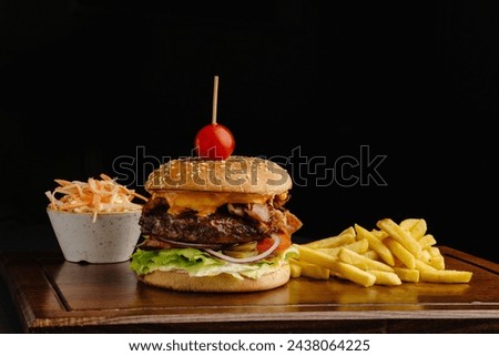 Juicy beef burger with melted cheese, crispy bacon, fresh tomato, lettuce, onion, golden fries, and creamy coleslaw. Perfect for burger fans. High-quality stock photo on dark background.