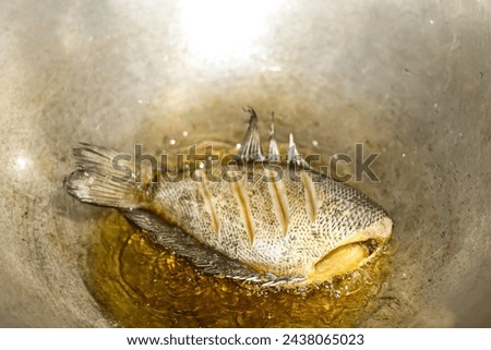 Pictures of fish fire in the pan, concept cooking and food.