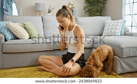 Young caucasian woman with dog speaking on the phone sitting on floor at home