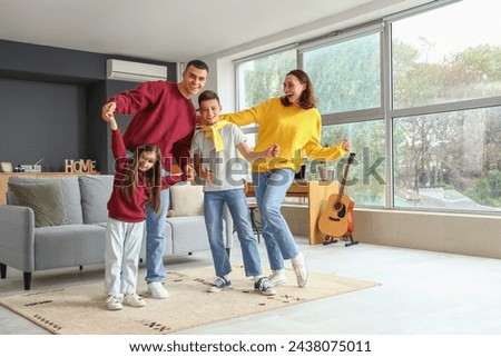 Little children with their parents dancing at home