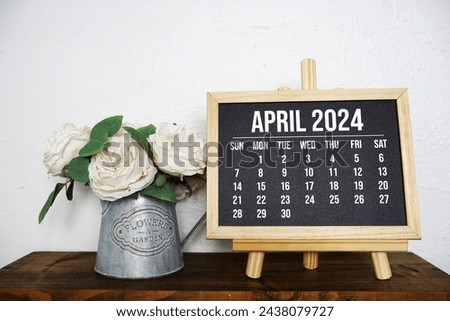 April 2024 monthly calendar with flower bouquet decoration on wooden background Royalty-Free Stock Photo #2438079727
