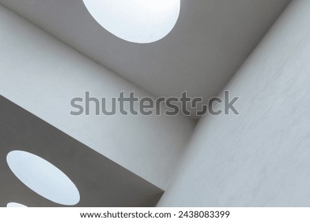 White ceiling structure with round skylight portals, abstract minimal architecture background, blue toned photo