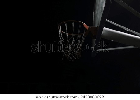 view of the basketball hoop at an empty playground outdoor court at night. Side view of basketball hoop at night. basketball court illuminated only by night sky, basketball hoop, game in urban setting
