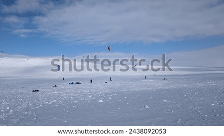 Snowkiting group in norwegian area Hardangervidda. Royalty-Free Stock Photo #2438092053