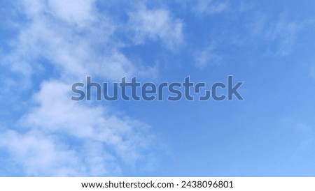 Blue sky with blurry white and fluffy clouds.Tenderness, dreams and inspiration. Copy space. Beautiful abstract background. Fresh air. Environment. Freedom. Atmospheric conditions. Celestial wonders. Royalty-Free Stock Photo #2438096801