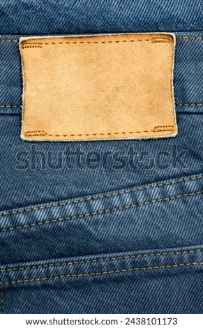 Blank leather label with abstract product background. Royalty-Free Stock Photo #2438101173