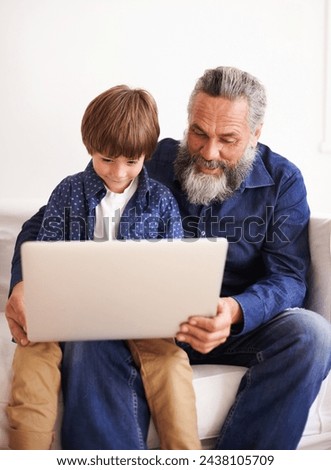 Grandfather, son and laptop on sofa with love and bonding together with online games in living room. Happy family, boy and computer for cartoons in lounge, relax and movie subscription on holiday