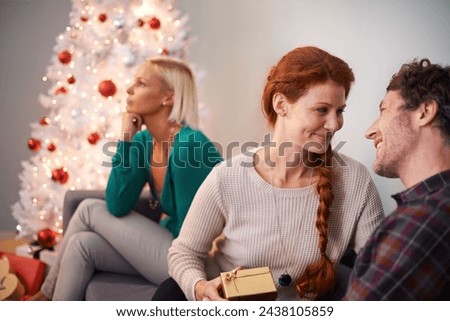 Box, couple and Christmas tree for gift giving or person lonely on sofa or festive season, unhappy or thinking. Man, women and present in living room at winter break or holiday, vacation or event