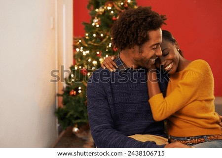Couple, embrace and Christmas holiday at tree in apartment living room for festive season celebration, vacation or decoration. Man, woman and hug bonding for relaxing connection, present or break