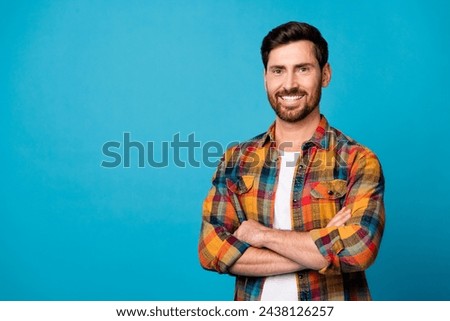 Photo portrait of handsome young male crossed hands confident pose wear trendy plaid outfit isolated on blue color background