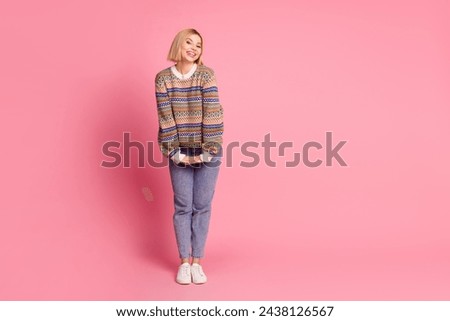 Full length photo of pleasant cheerful girl dressed print sweater jeans trousers hold arms together isolated on pink color background
