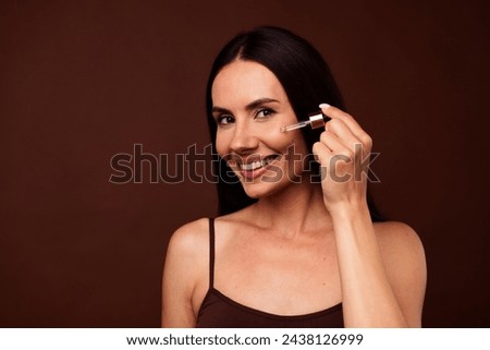 Photo portrait no filter of pretty young girl face apply serum cheek dressed stylish underwear isolated on brown color background
